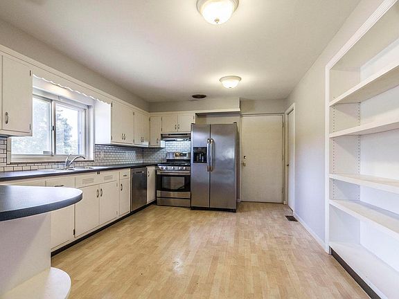 Kitchen displaying all stainless steel appliances