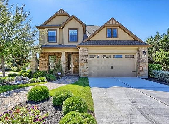 home from curb with sidewalk and long driveway