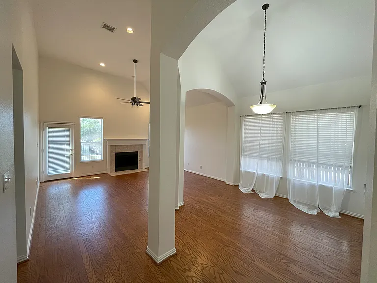 living/dining area with 14' ceiling and view to the green space off the patio
