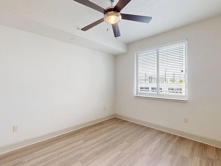 Apartment bedroom with wood style floor.