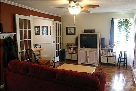 Hardwoods and new ceiling fan in living room.