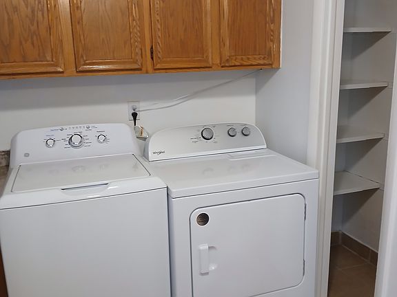 Washer/ Dryer and Large Pantry with Light