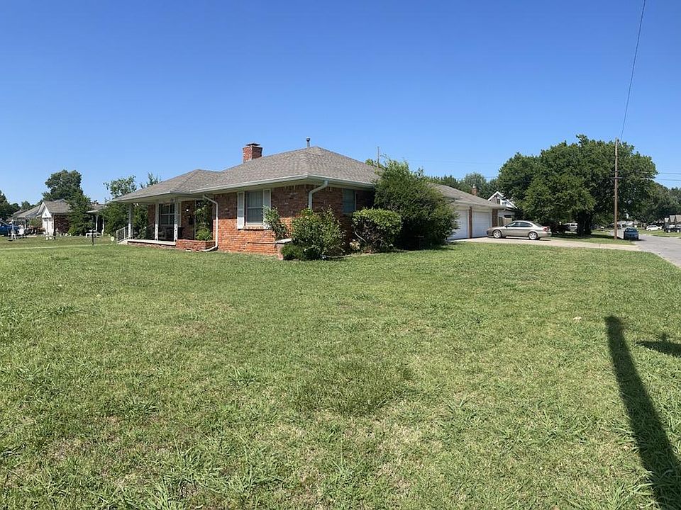 Southwest Corner of house showing front and garages.