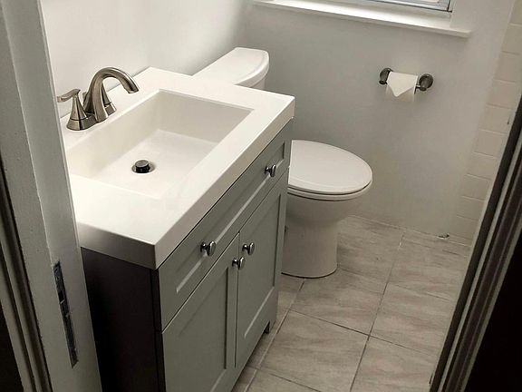 Bathroom with pocket door, large window and skylights