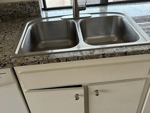 Kitchen sink area with new faucet and granite counter tops.
