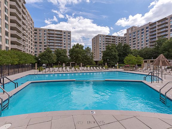 Olympic-Sized Pool with Swimming Lanes, Free Swim Area, and Expansive Sundeck with Chaise Lounge Chairs