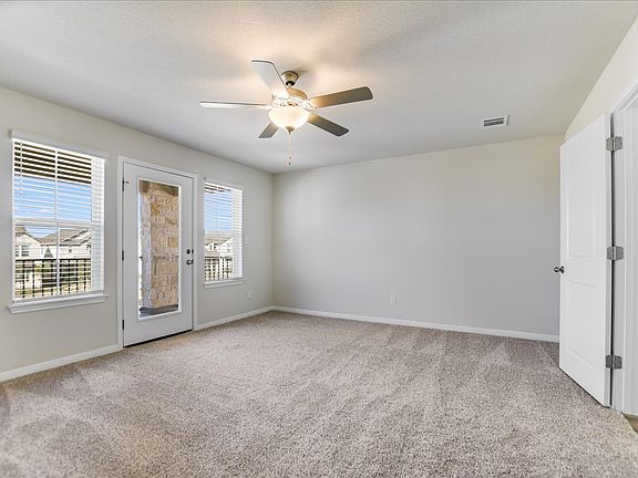 This primary bedroom comes with a balcony great for a nice weather day.