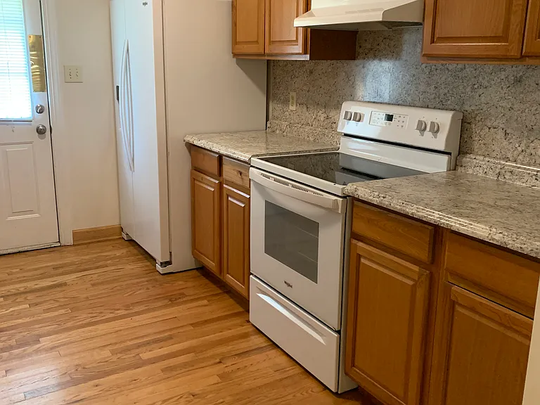 Kitchen showing range and refrigerator