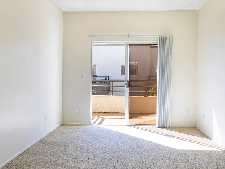 Carpeted Bedroom with Balcony