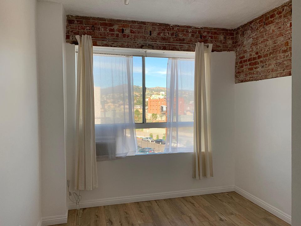 Exposed brick in bedroom with AC included.