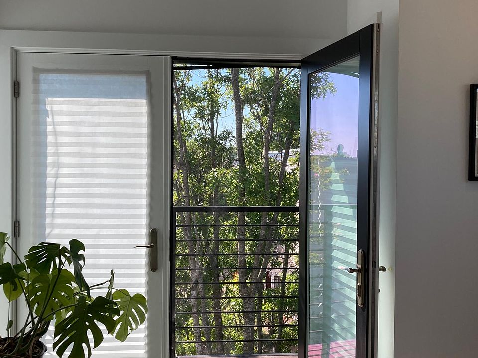 Master bedroom balcony opens out to a beautiful tree that also offers additional privacy (shown furnished).