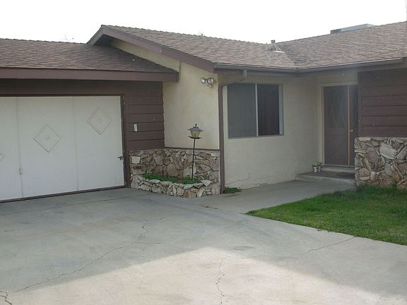Southwest view from driveway. Garage and front entry visible.