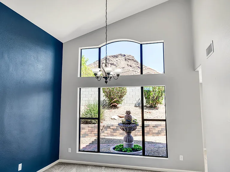 Two-story living room highligning mountain view