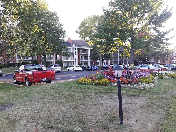 Three story building. The paking lot in front of the buildin