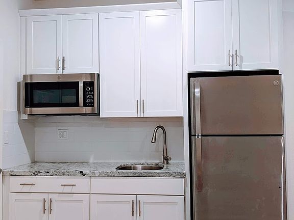 Sleek, modern kitchenette designed for efficiency. Includes a high-end multi-function microwave/convection oven and premium Refrigerator with an ice maker, perfect for preparing simple, delicious meals in your own private living space.