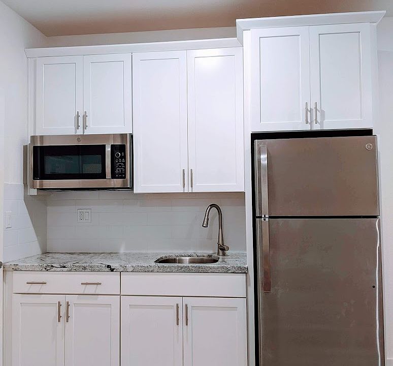 Sleek, modern kitchenette designed for efficiency. Includes a high-end multi-function microwave/convection oven and premium Refrigerator with an ice maker, perfect for preparing simple, delicious meals in your own private living space.