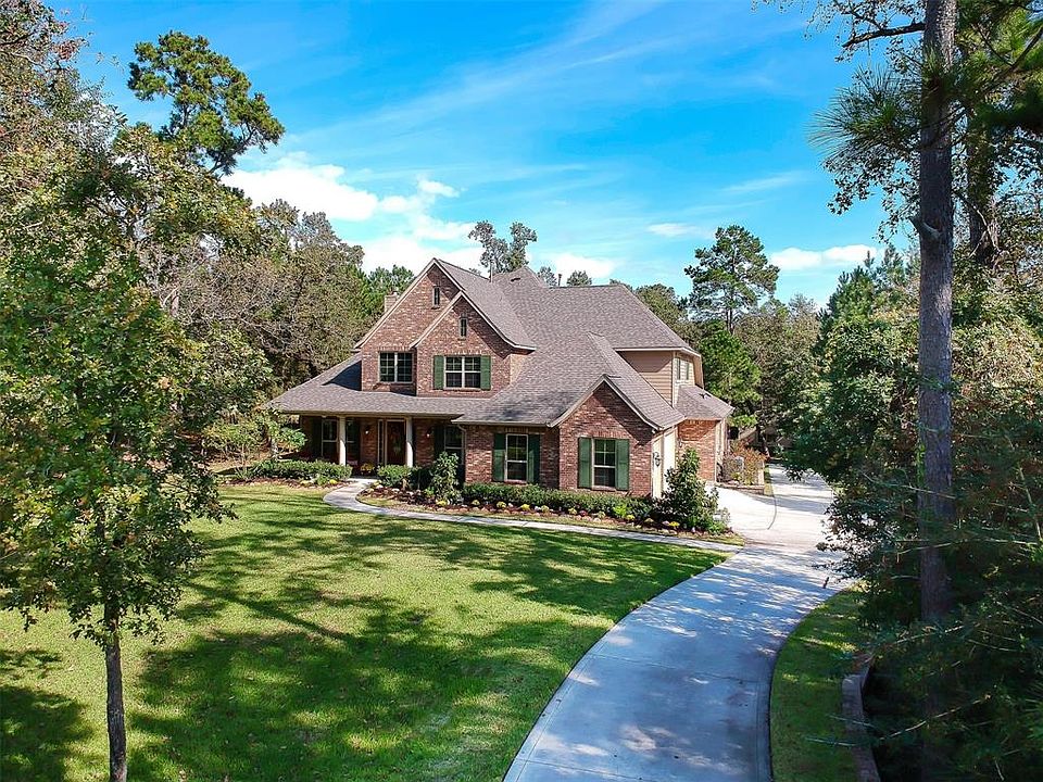 Welcome to your new home with wooded privacy in the wonderful acreage community of Ridge Lake Shores!