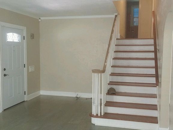 Living Room Stairs to 3 BRs and main BA