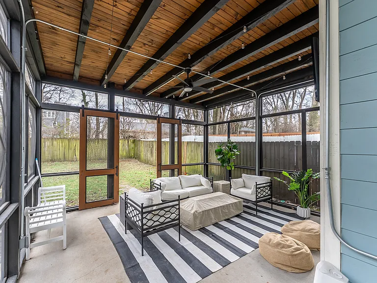 Covered patio with market lights, ceiling fan, screened in with TV.