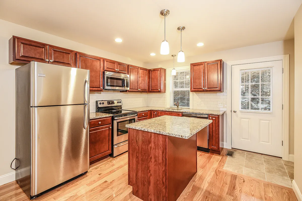 Maple wood cabinets, granite countertops and stainless steel appliances. - The Hills at River View