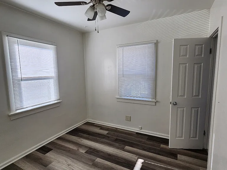bedroom with ceiling fan & new vinyl flooring