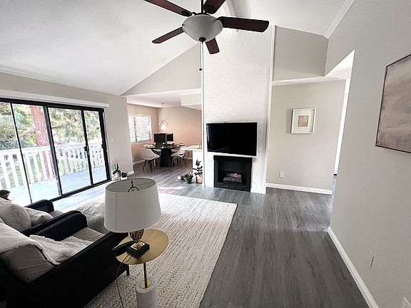 Living room with balcony on left, entrance on right and dining room left of the fireplace.