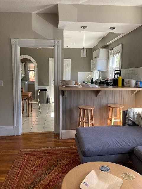 Looking from the living room into kitchen, laundry, pantry
