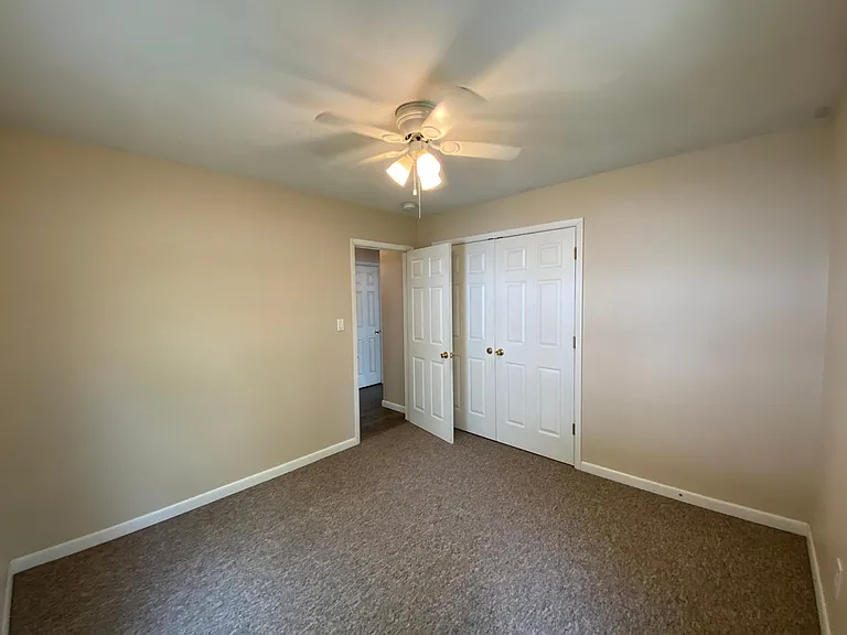 Closet area of front bedroom and door to hallway of east bedroom wing.