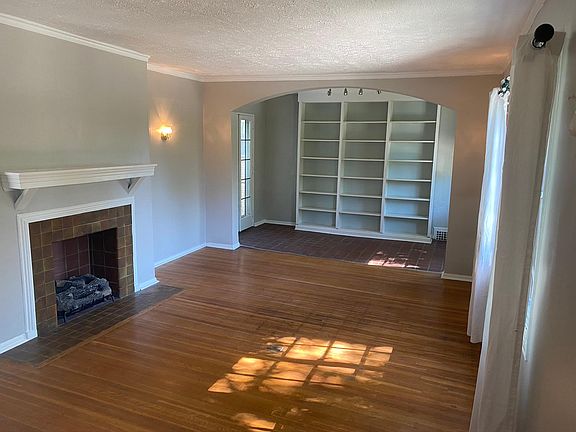 Enter into large living room with gas log fireplace.