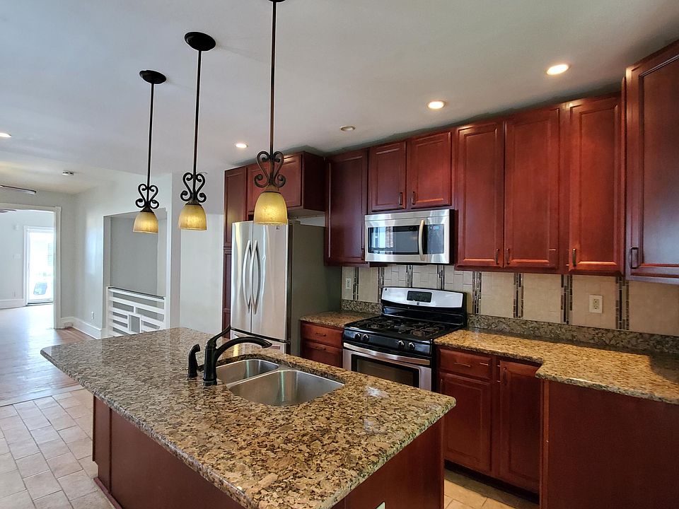 Updated kitchen boasts beautiful cherry cabinets & pantry closet with stainless steel appliances, gas range, garbage disposal & dishwasher.