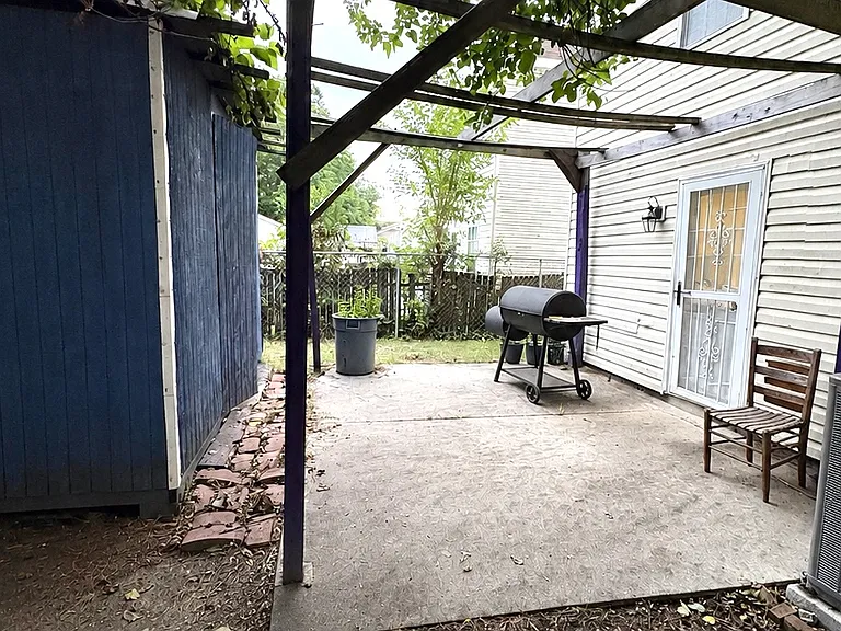 Fenced in backyard with patio
