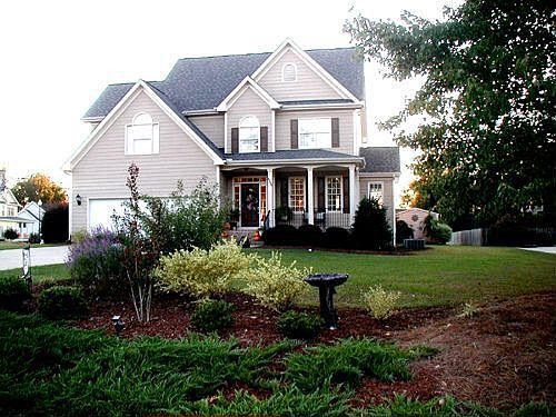 Home with front porch on 2.3 acre level lot landscaped lot 