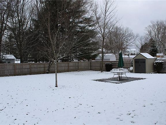Fully fenced yard with shed and patio