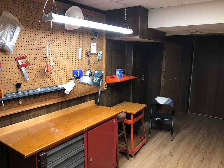 Basement workshop/project room/ multipurpose room. At back right sliding door to storage closet