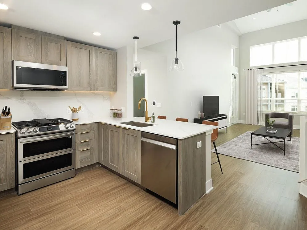 Signature Collection kitchen and living room with hard surface flooring - Avalon Montville