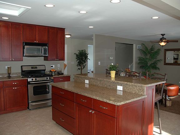 Kitchen with Island/Breakfast Bar, Recessed Lights, & Skylight