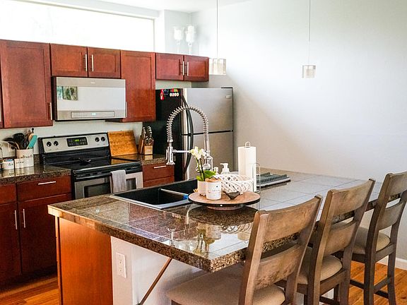Kitchen with stainless steel appliances and causal eating