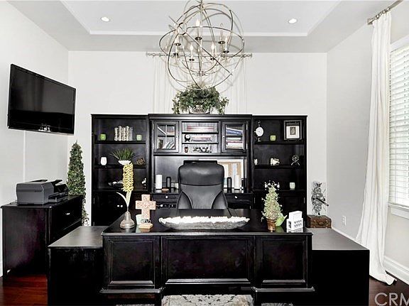 The executive office is set at the front of the house with a lovely view of the lush front yard.