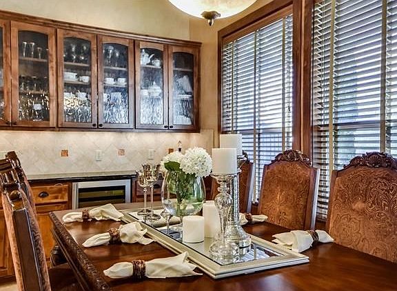 Dry bar, custom cabinetry and tons of natural light fill this dining area.