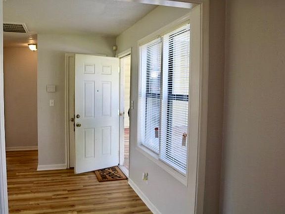 View of living room/front door from dining area/kitchen.