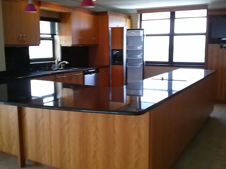 Kitchen island with gorgeous dark granite and real maple cab