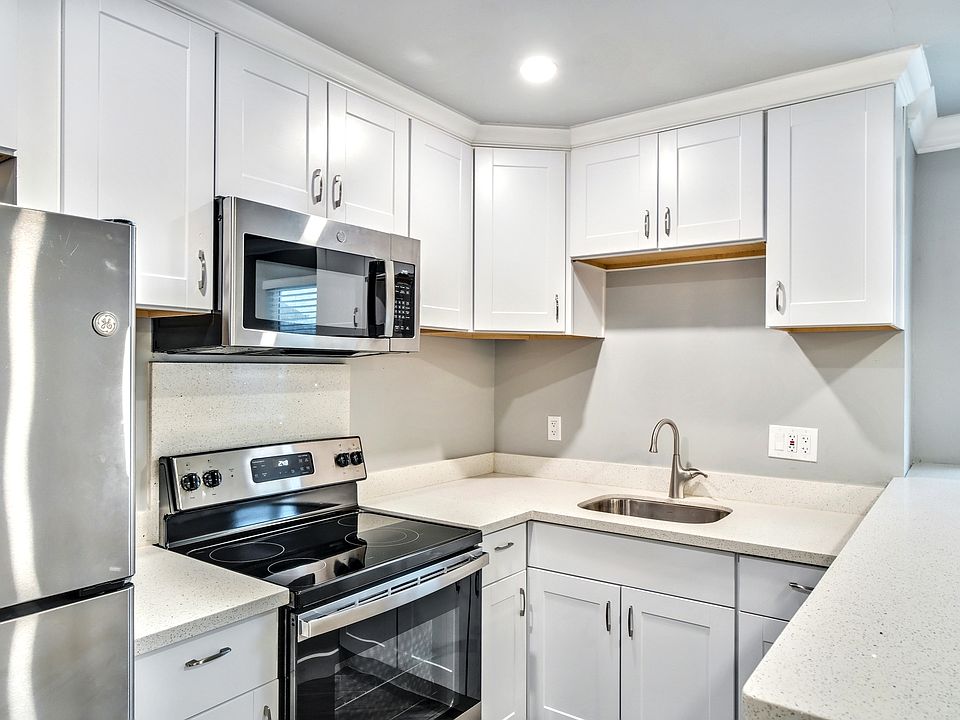 Kitchen with stainless steel appliances, freezer with ice maker, and garbage disposal