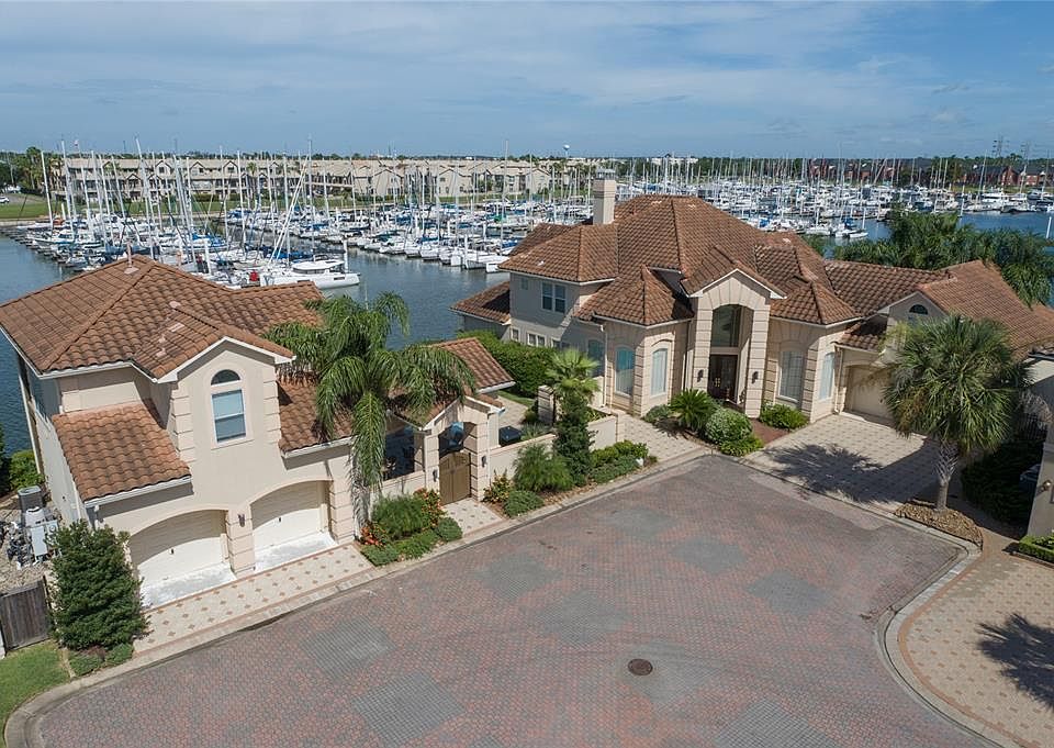 FRONT ELEVATION HIGHLIGHTS THE PRIVACY OF THE POINT AND THE ADDED BENEFIT OF PARKING INCLUDING (2) 2 CAR GARAGES AND 2 DRIVEWAYS.