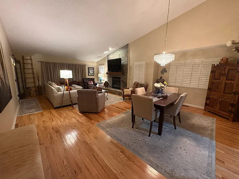 Large LR and DR area with vaulted ceiling, stone fireplace with gas logs, plantation shutters.