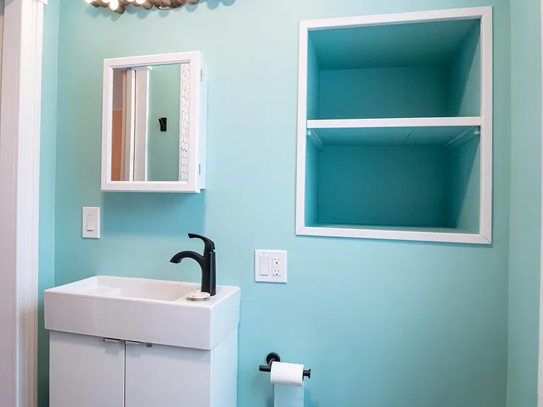 bathroom featuring hexagon tile floor, sink c vanity and built in storage