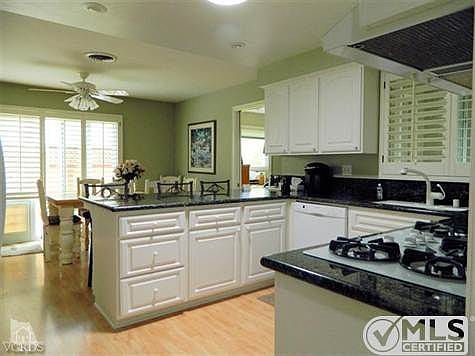 Kitchen as you look on from front entry. Dining area in back of photo. Doorway To right in photo lea