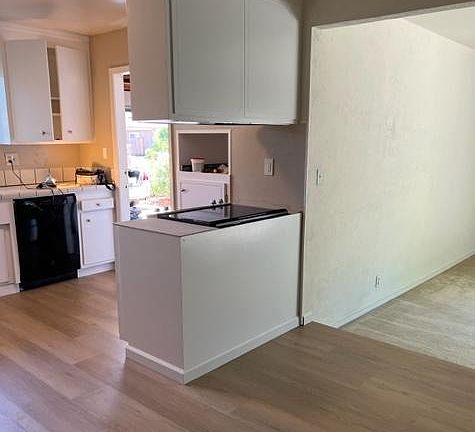 Large eating area adjacent to kitchen. New floors.