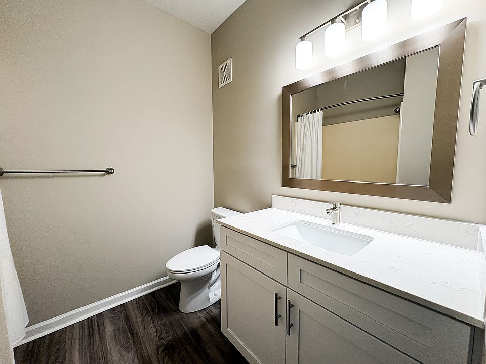 Newly renovation bathroom with white granite vanity and stainless steel finishes.