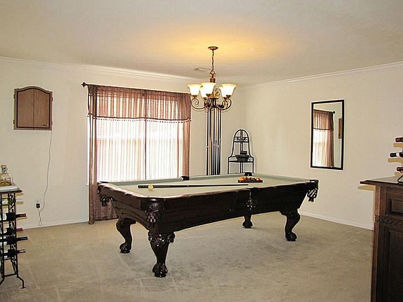 Large formal dining room features crown molding.