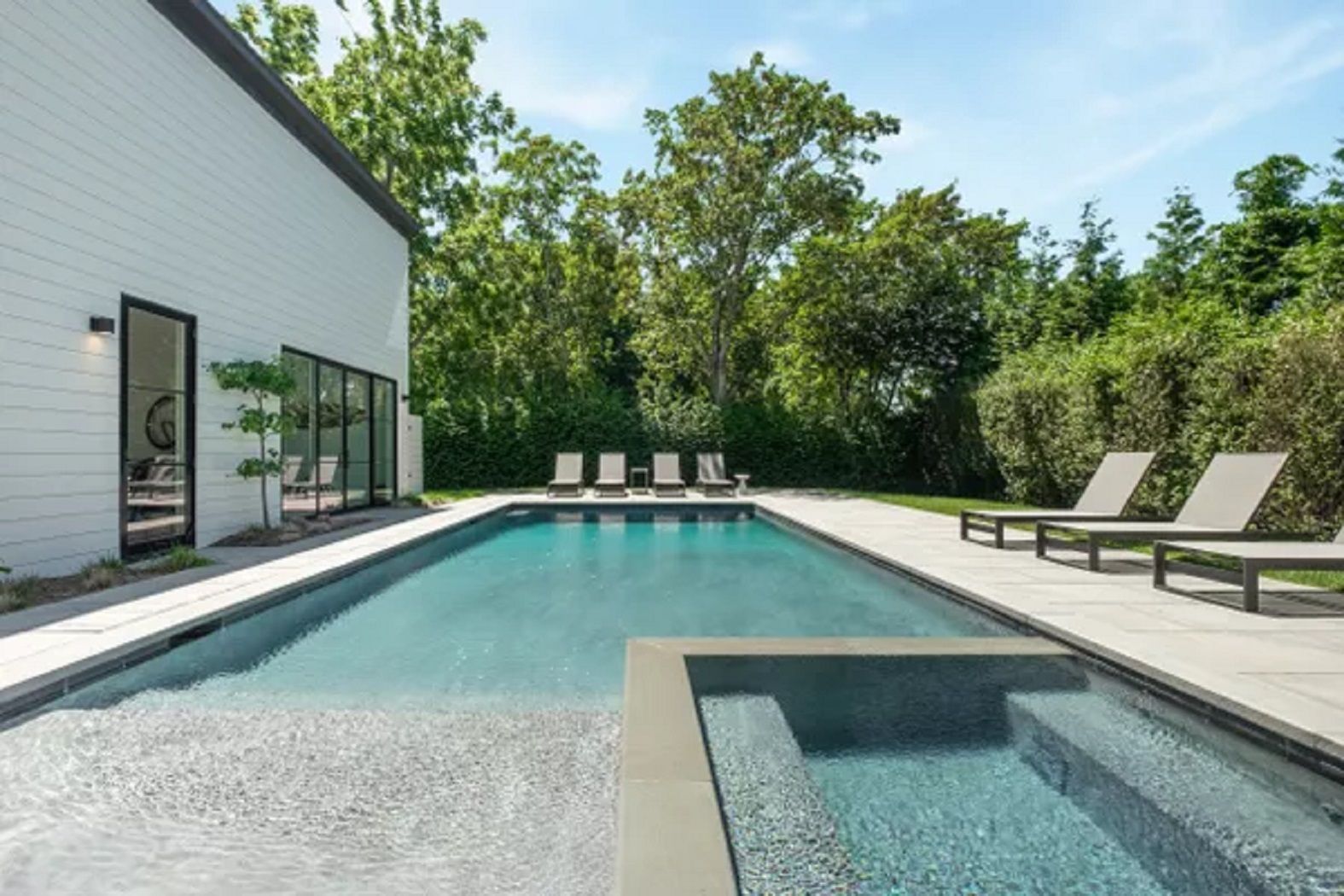 Pool pavilion with bluestone deck, heated pool and spa, entry to pool house and garage